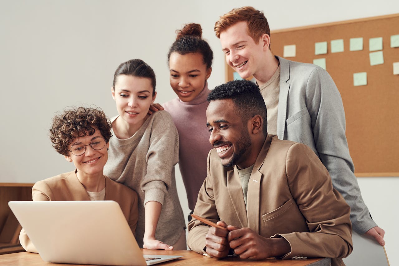 group of people in front of laptop