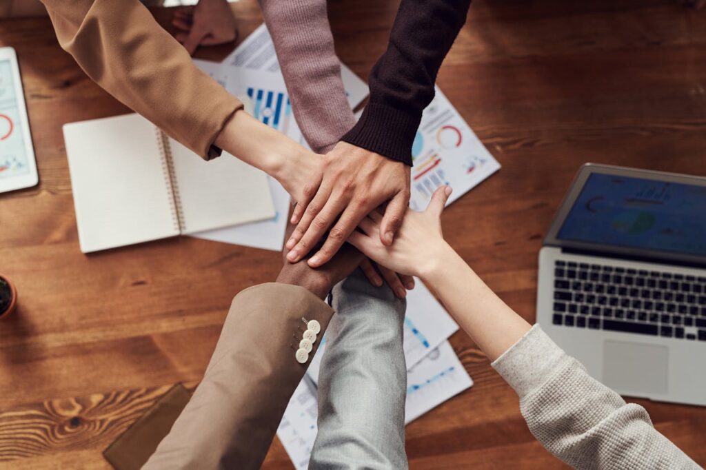 people cross hands at the table